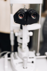 Fototapeta na wymiar Microscopic apparatus for testing eyesight. Ophthalmology and treatment of eye diseases. Eye clinic, optometrist concept