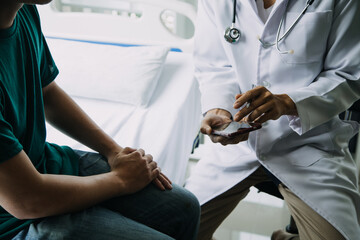 Doctor and patient discussing something while sitting at the table . Medicine and health care concept. Doctor and patient