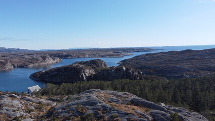 Norwegian Sea. Rocks near the sea coast. Beautiful sea water. Blue sky and nice sun rays