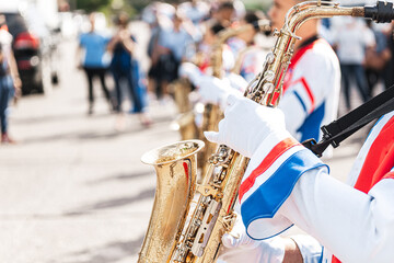 Closeup of saxophonists playing a saxophone.