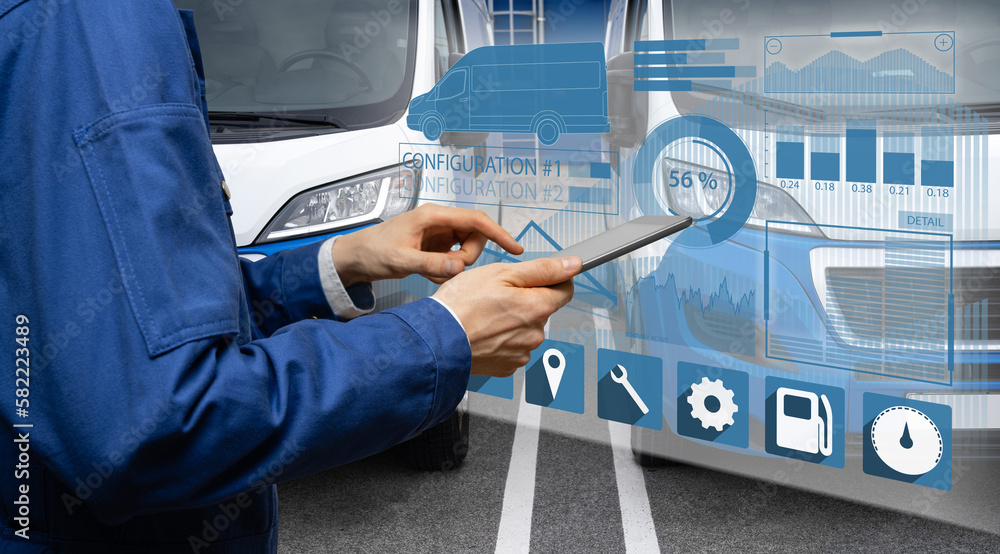 Poster Manager with a digital tablet on the background of vans. Fleet management

