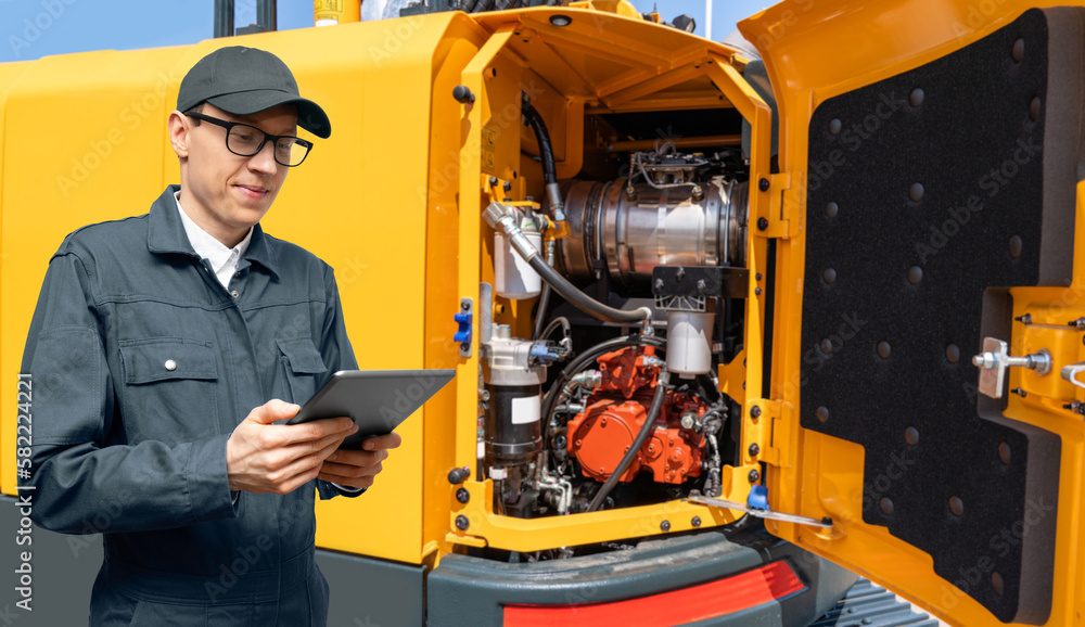Aufkleber serviceman with digital tablet on the background of construction machine
