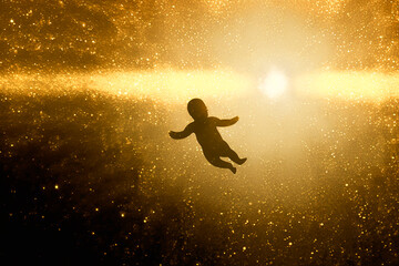 Fototapeta na wymiar silhueta de bebe em luz dourada, energia vital da vida 