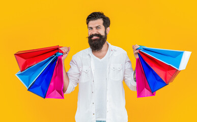 shopaholic man in yellow studio. shopaholic man on yellow background.