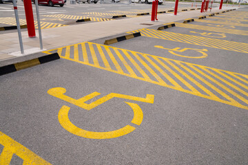 Parking lot for disabled with yellow symbol