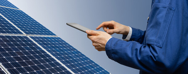 Engineer with tablet computer on a background of solar energy power station