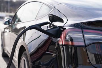 Close-up of an electric car with a charging cable 