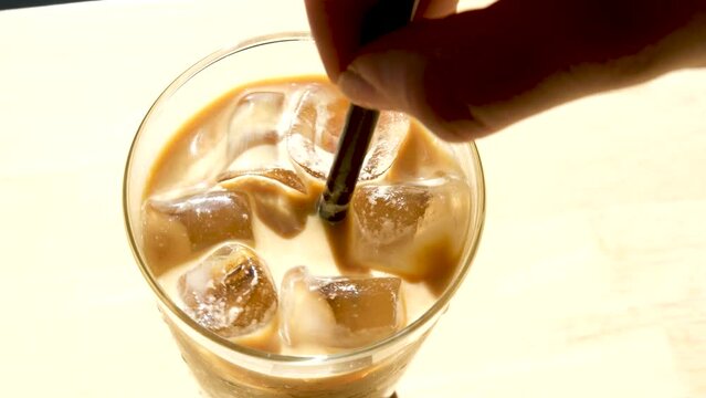 iced coffee close up stiriing. High quality 4k footage