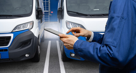 Manager with a digital tablet on the background of vans. Fleet management	