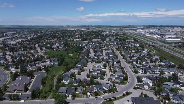 mid-day summer panoramic views over a small city with lush greenery and happy modest houses