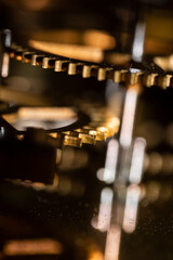 The mechanism of an old watch. clock mechanism made in the technique of toning. Focus on the central gears. Very shallow depth of field