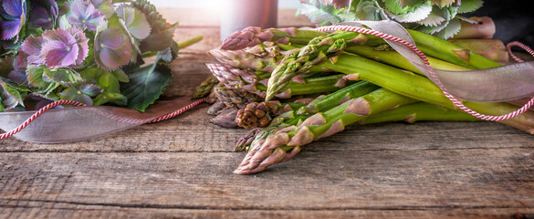 Green asparagus stylish presented on vintage wood. Stil life for a seasonal and healthy gastronomy...