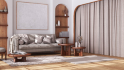 Blurred background, wooden living room in boho style with arched door and parquet floor. Fabric sofa, carpet, shelves and table. Bohemian interior design