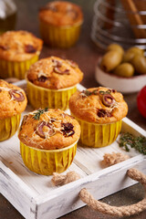 Muffins with green olives, sun dried tomatoes and cheese. Delicious homemade savory appetizer.