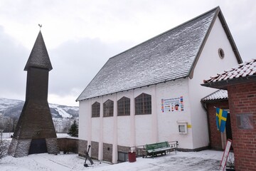 The Norwegian port city of Narvik with ancient church in winter scenery