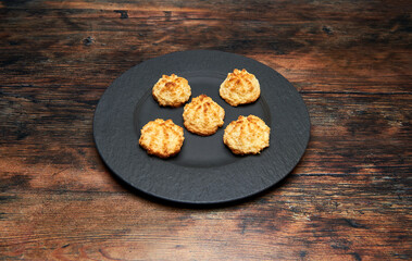 cookies made of coconut, flour, egg and flour on black rock plate