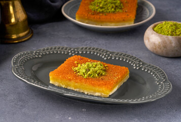 Middle eastern sweets kunefe, kunafa, kadayif with pistachio .Turkish , arabic traditional dessert.