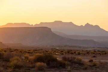 Sunsetting over the buttes and desert terrain in Virgin, Utah.