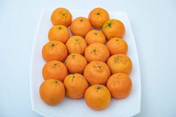 tangerine on a white background. How to choose, store and how much you can eat so as not to harm the body.	