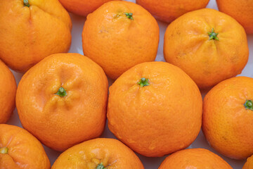 tangerine on a white background. How to choose, store and how much you can eat so as not to harm the body.	