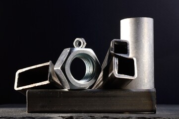 composition of nuts bolts and scraps of metal laid out on a dark background.