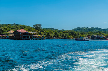 A view from a boat leaving West Bay on Roatan Island on a sunny day