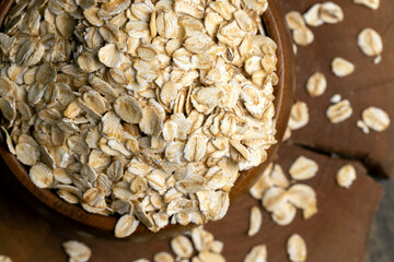 Oat flakes scattered on a wooden surface