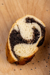 Fresh bun with poppy seed filling on the table
