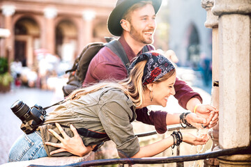 Young hipster couple in love having genuine fun wandering at city center - Wanderlust life style...