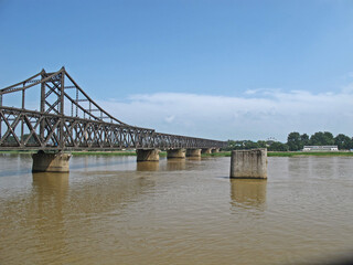 Fototapeta na wymiar The Linjiang Yalu River Bridge, a connection between North Korea and China