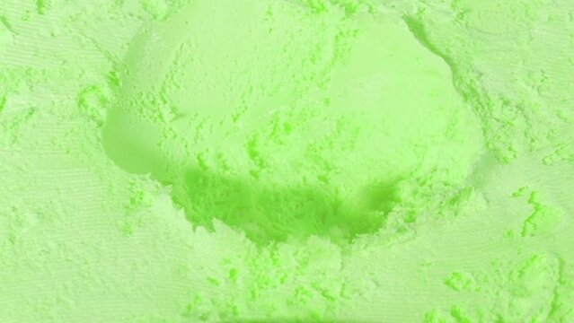 Person Scoops Mint Flavor Ice Cream With Spoon