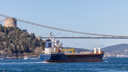 Naklejka premium Tanker ship pass through the Bosporus with Bosphorus Bridge in Istanbul, Turkey or Turkiye, Bosphorus strait connecting Europe to Asia, Tanker ship in Istanbul, Turkey.
