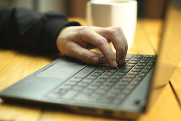 a person typing on a laptop keyboard