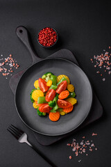 Salad of fresh and steamed vegetables cherry tomatoes, broccoli and carrots