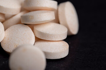 White and yellow medical medicines on a black background