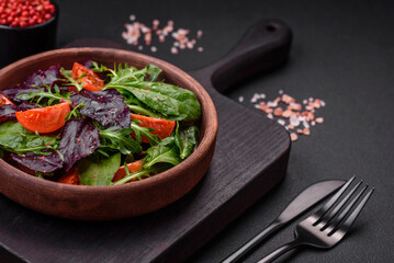 Salad of fresh cherry tomatoes, arugula, spinach and young beet leaves