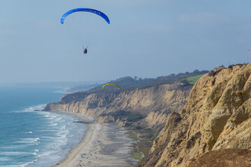 Gliding off the San Diego coast and over Blacks beach. Paragliding.