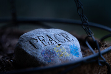 A rock with "Peace" carved into it