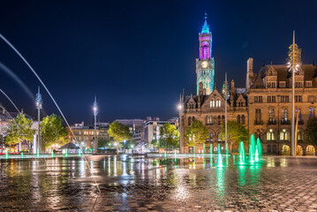 Night view of illuminated clock tower and fountain at  Centenary Square Bradford UK