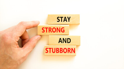 Stay strong and stubborn symbol. Concept words Stay strong and stubborn on wooden block. Beautiful white table white background. Motivational business stay strong and stubborn concept. Copy space.
