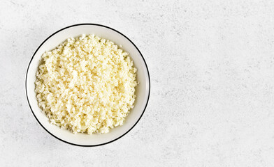 Raw cauliflower rice in bowl