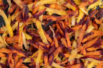 Finely grated red-orange carrots in the kitchen