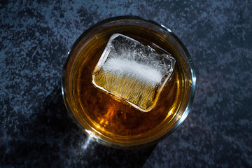Alcohol beverage whisky in a glass with ice cube