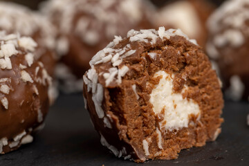 Chocolate candies in the form of balls with milk coconut