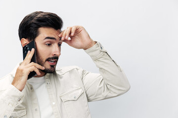 Closeup portrait man talking on the phone angry annoyance and quarrel on white isolated background, fashion style clothes, copy space, space for text