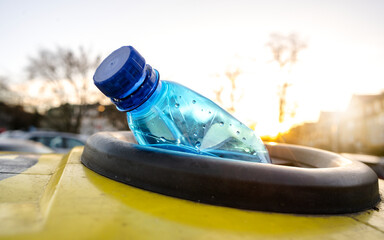 A Used Plastic Bottle Thrown into a Sorted Recycling Container, an Ecological Solution for a Better Natural Environment