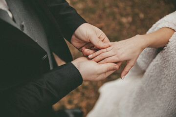 Hands of wedding couple with ring
