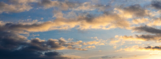 Fototapeta premium Dark clouds in the blue sky during sunset