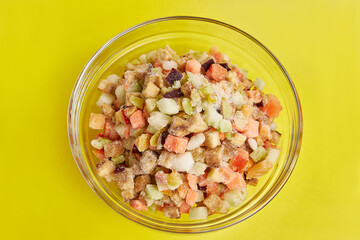 A bowl of chopped frozen vegetables. Cooking dishes from vegetables. Eggplants, tomatoes, zucchini, peppers, onions.