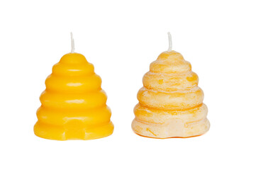 A beeswax candle with wax bloom next to a candle without wax bloom